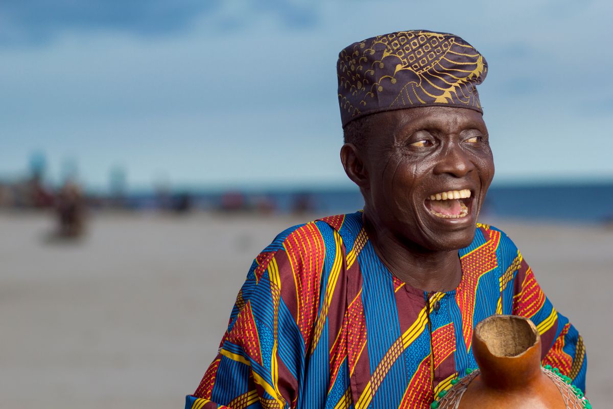 An older patient smiling broadly after dental restoration