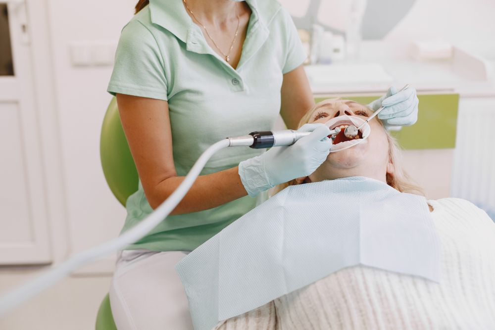 A dental hygienist performing a professional cleaning