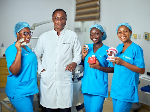 Dr. Asante with the De Santi Dental team